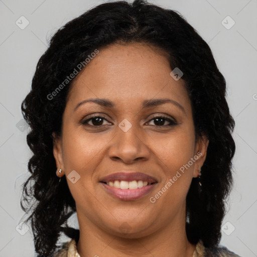 Joyful black young-adult female with long  brown hair and brown eyes