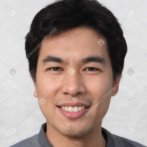 Joyful white young-adult male with short  black hair and brown eyes