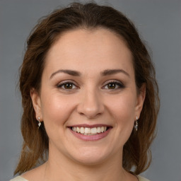 Joyful white young-adult female with medium  brown hair and brown eyes