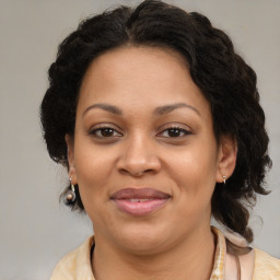 Joyful latino adult female with medium  brown hair and brown eyes