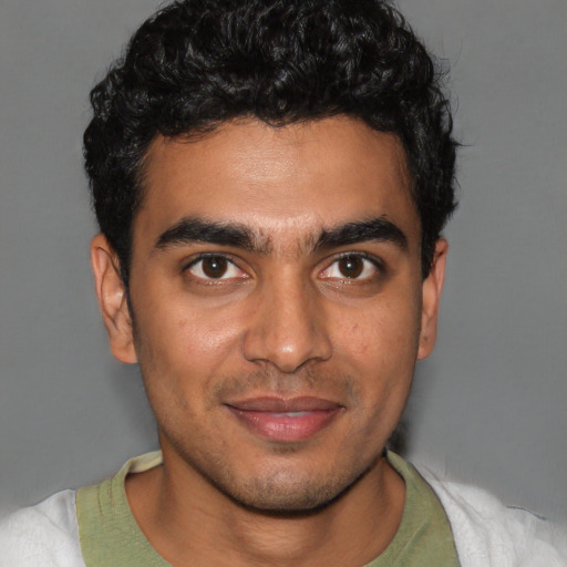 Joyful latino young-adult male with short  brown hair and brown eyes