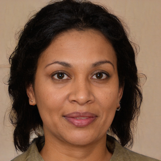 Joyful black adult female with medium  brown hair and brown eyes