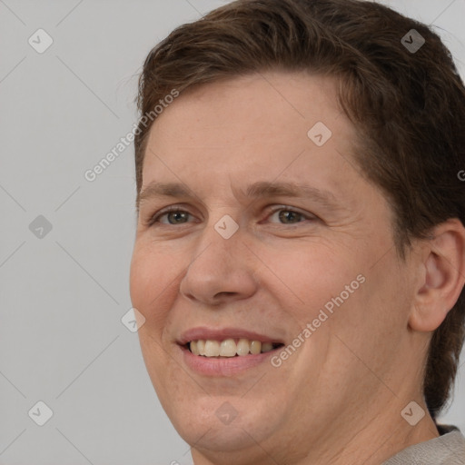 Joyful white adult female with short  brown hair and brown eyes