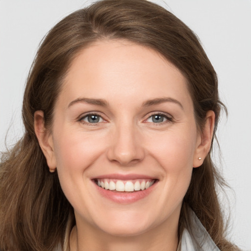 Joyful white young-adult female with long  brown hair and grey eyes