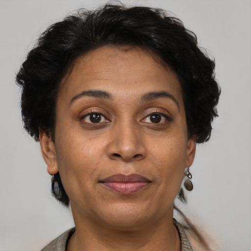 Joyful latino adult female with short  brown hair and brown eyes