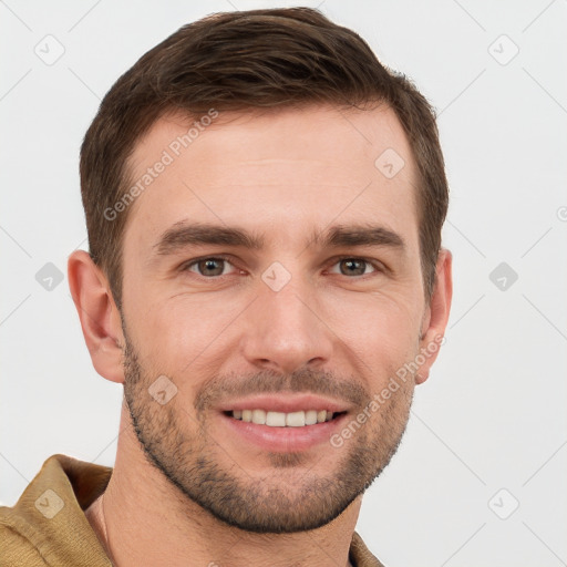 Joyful white young-adult male with short  brown hair and grey eyes