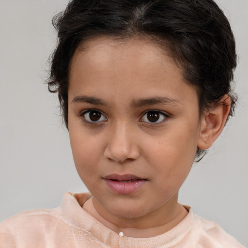 Joyful white child female with short  brown hair and brown eyes