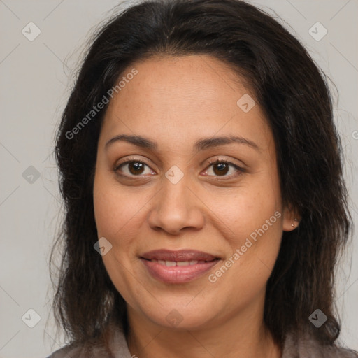 Joyful latino adult female with medium  brown hair and brown eyes