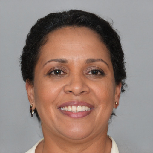 Joyful black adult female with short  brown hair and brown eyes