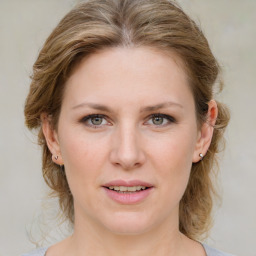 Joyful white young-adult female with medium  brown hair and blue eyes