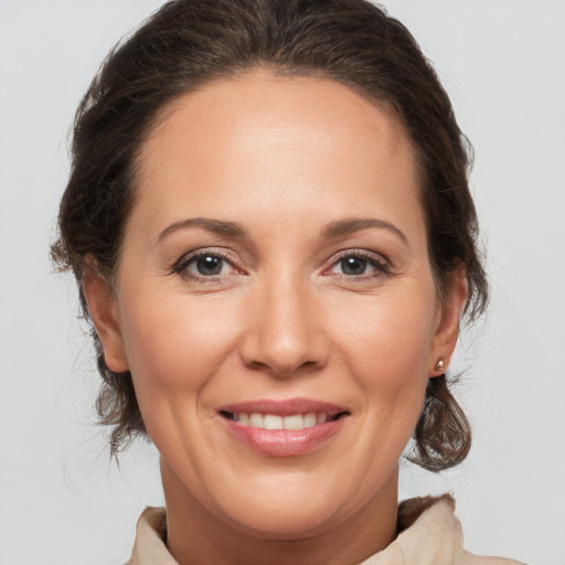 Joyful white adult female with medium  brown hair and brown eyes