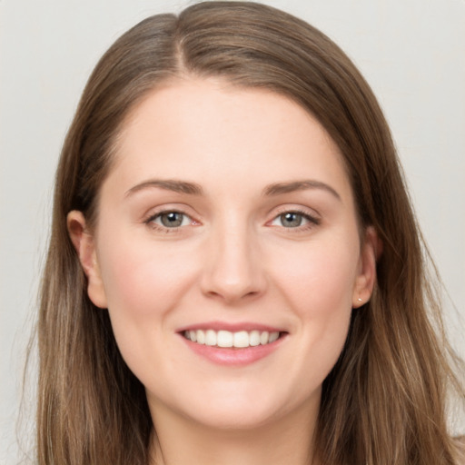 Joyful white young-adult female with long  brown hair and grey eyes