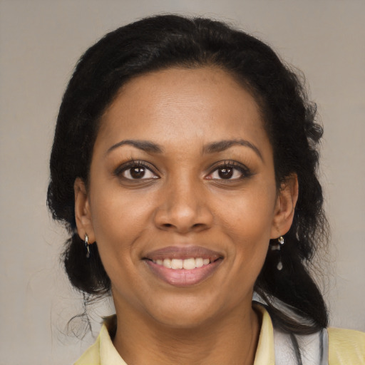 Joyful black young-adult female with medium  brown hair and brown eyes
