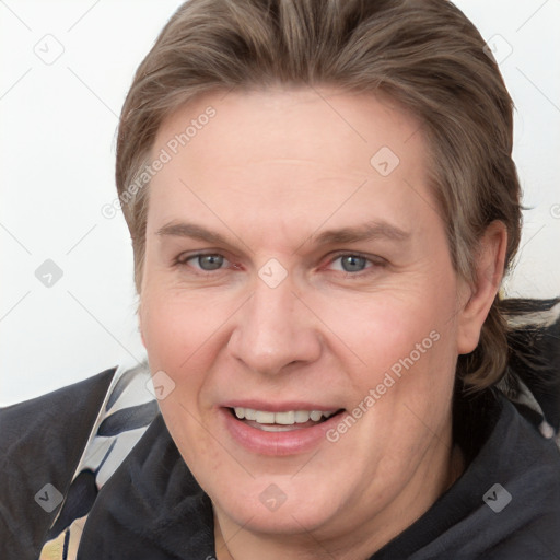 Joyful white adult female with medium  brown hair and grey eyes