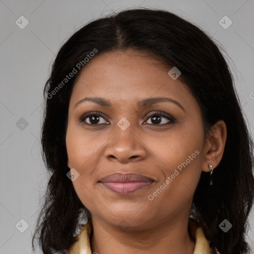 Joyful black adult female with long  brown hair and brown eyes