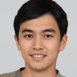 Joyful asian young-adult male with short  black hair and brown eyes