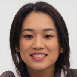 Joyful asian young-adult female with long  brown hair and brown eyes