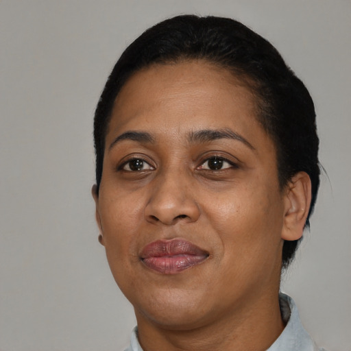 Joyful black adult female with short  black hair and brown eyes