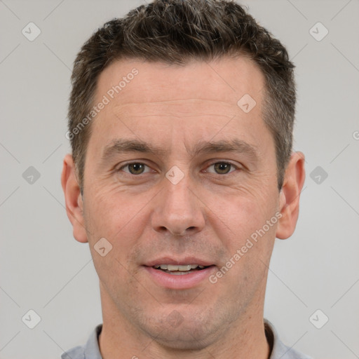 Joyful white adult male with short  brown hair and brown eyes