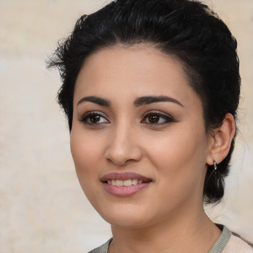 Joyful latino young-adult female with medium  black hair and brown eyes