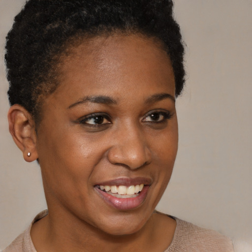 Joyful black young-adult female with short  brown hair and brown eyes