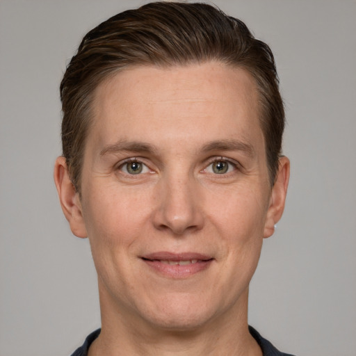 Joyful white adult male with short  brown hair and grey eyes