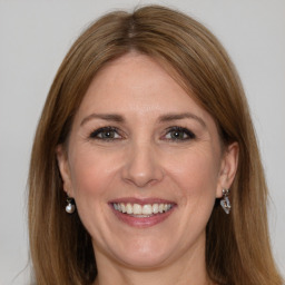 Joyful white adult female with medium  brown hair and grey eyes