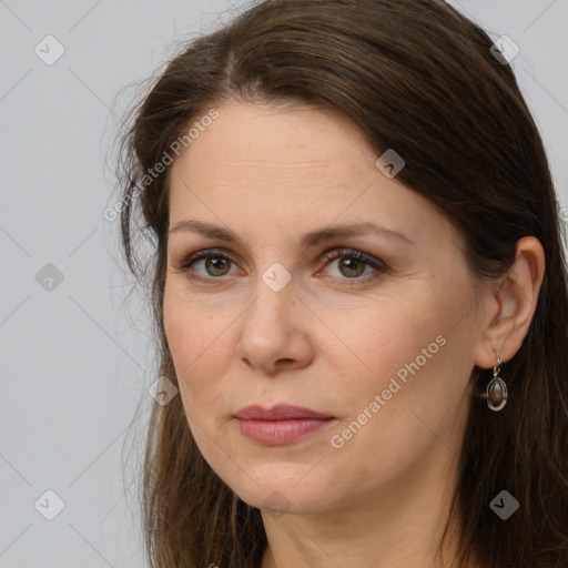 Joyful white adult female with long  brown hair and brown eyes