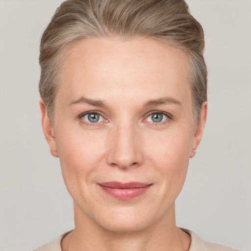 Joyful white adult female with short  brown hair and grey eyes