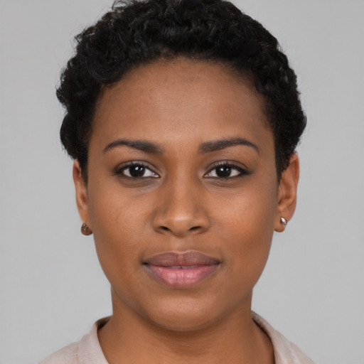 Joyful black young-adult female with short  black hair and brown eyes