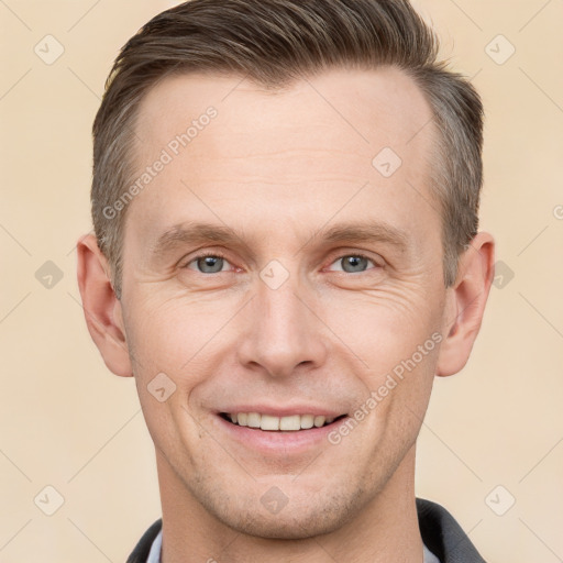 Joyful white adult male with short  brown hair and grey eyes