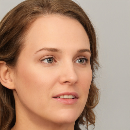 Joyful white young-adult female with medium  brown hair and green eyes