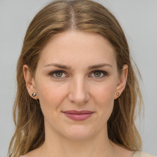 Joyful white young-adult female with medium  brown hair and grey eyes