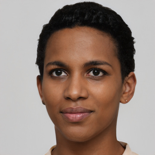 Joyful black young-adult female with short  black hair and brown eyes