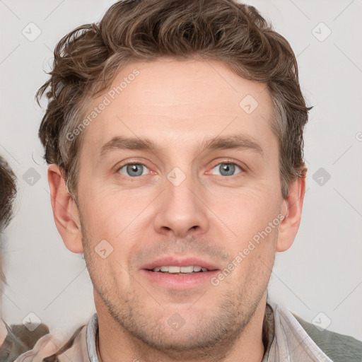 Joyful white adult male with short  brown hair and grey eyes