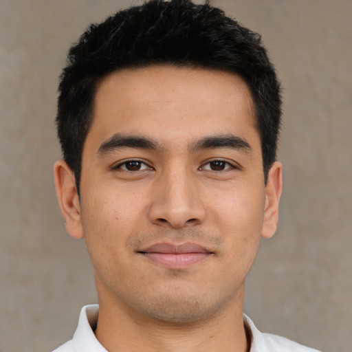 Joyful asian young-adult male with short  black hair and brown eyes