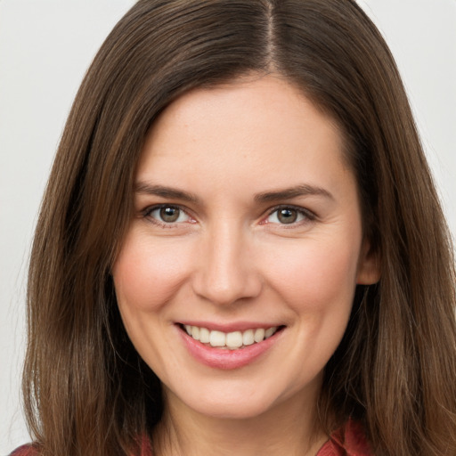 Joyful white young-adult female with long  brown hair and grey eyes