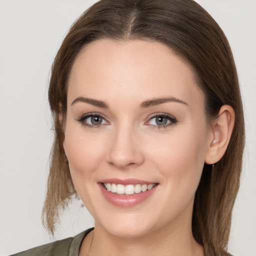 Joyful white young-adult female with long  brown hair and grey eyes