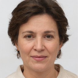 Joyful white adult female with short  brown hair and brown eyes