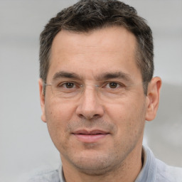 Joyful white adult male with short  brown hair and brown eyes