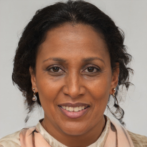 Joyful black adult female with medium  brown hair and brown eyes