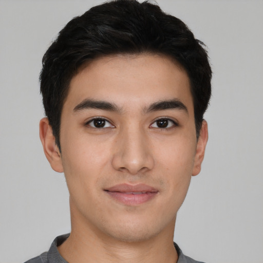 Joyful asian young-adult male with short  black hair and brown eyes