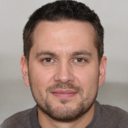 Joyful white adult male with short  brown hair and brown eyes