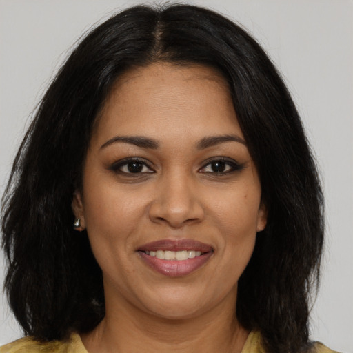 Joyful black young-adult female with medium  brown hair and brown eyes