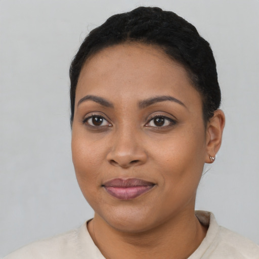 Joyful latino young-adult female with short  black hair and brown eyes