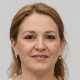 Joyful white adult female with medium  brown hair and grey eyes