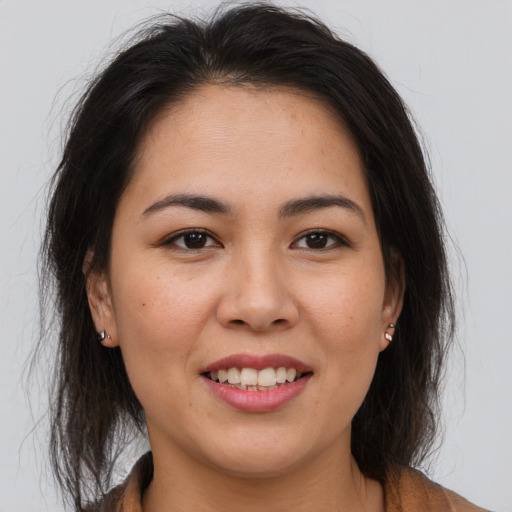 Joyful latino young-adult female with long  brown hair and brown eyes