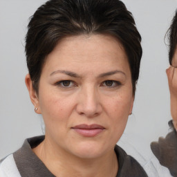 Joyful white adult female with short  brown hair and brown eyes