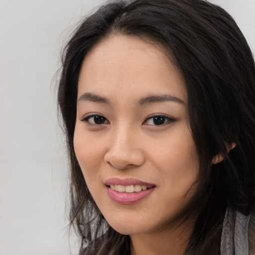 Joyful white young-adult female with long  black hair and brown eyes