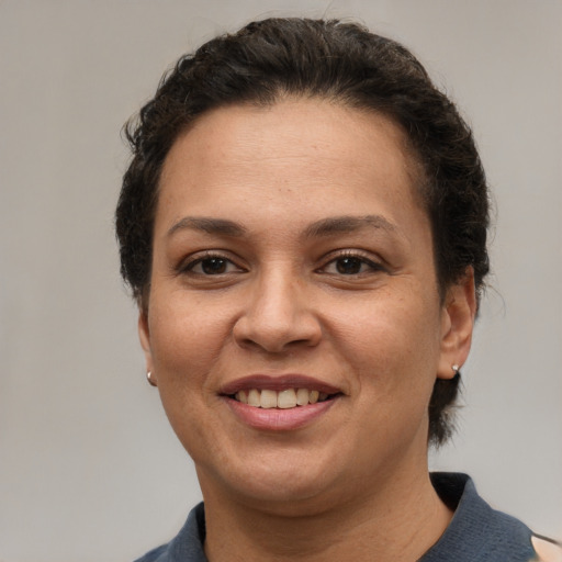 Joyful white adult female with short  brown hair and brown eyes